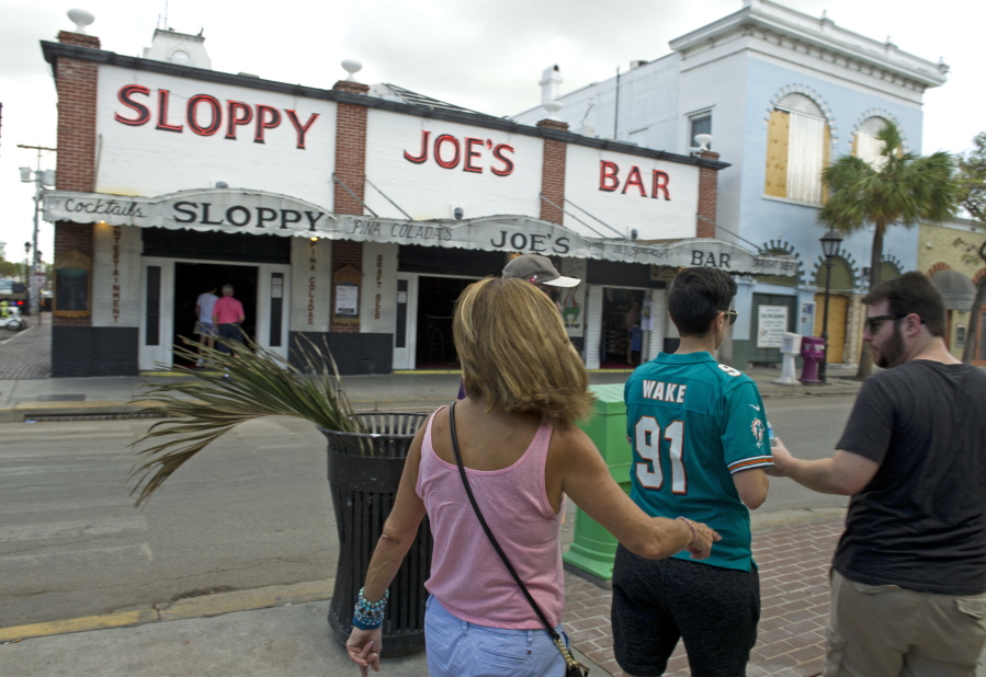 In this photo provided by the Florida Keys News Bureau, cruise ship tourists walk past Sloppy Joe’s Bar Sunday, Sept. 24, 2017, in Key West, Fla. The arrival of Royal Caribbean’s Empress of the Seas arrival was the first time a cruise ship has docked in Key West since prior to Hurricane Irma’s passage through the Florida Keys.