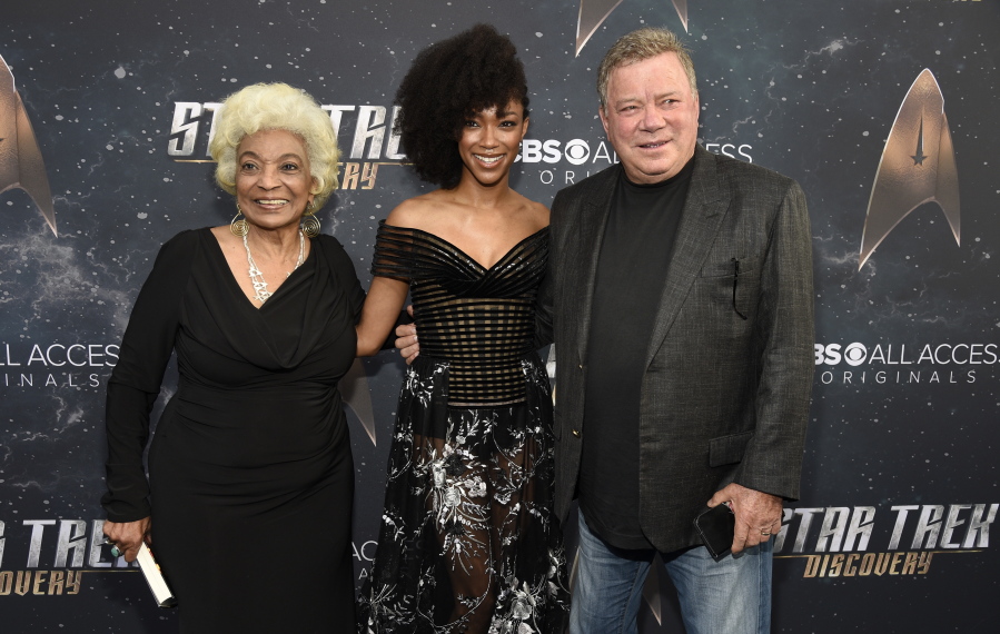 Sonequa Martin-Green, center, a cast member in “Star Trek: Discovery,” poses with original “Star Trek” cast members Nichelle Nichols, left, and William Shatner at Tuesday’s premiere of the new television series in Los Angeles. “Discovery” represents not only a new era in the “Trek” franchise, but also in television.