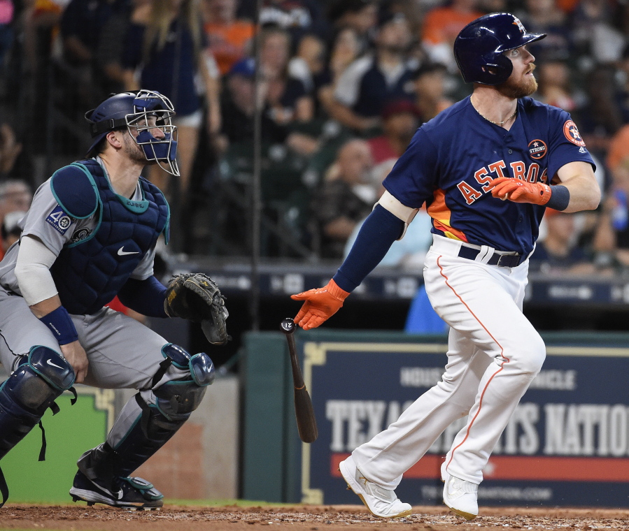 Houston Astros’ Derek Fisher watches his two-run home run off Seattle Mariners starting pitcher Andrew Moore during the fifth inning of a baseball game, Sunday, Sept. 17, 2017, in Houston.