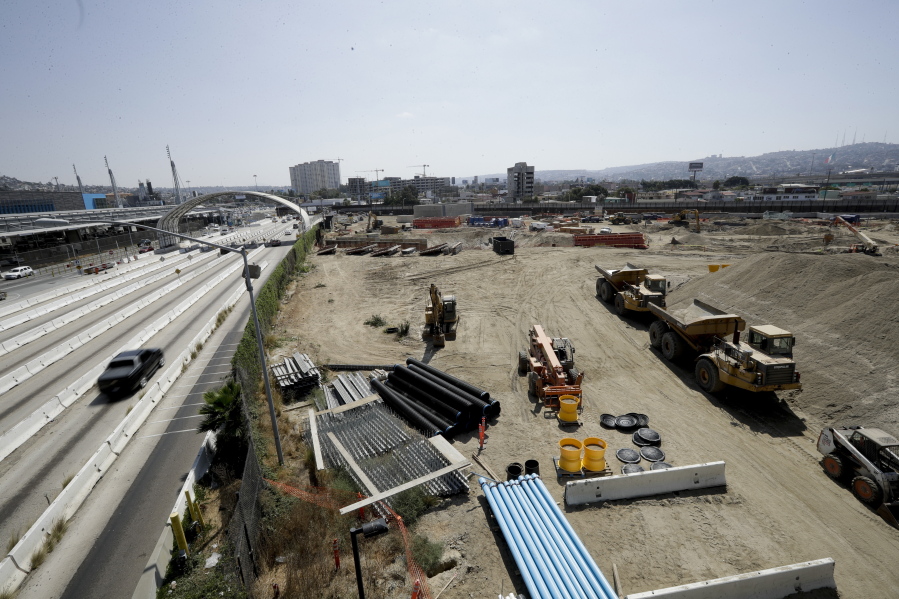 In this Tuesday, Sept. 19, 2017, photo, cars, left, move along California’s Interstate 5 as construction continues on a new curve as the highway approaches the border with Tijuana, Mexico, in San Diego. The busiest border crossing in the United States, between San Diego and Tijuana, will close this weekend to the more than 40,000 cars that pass through it daily to Mexico. The closure is for work on a $741 million expansion project that presents a monumental headache for border businesses, workers, tourists.