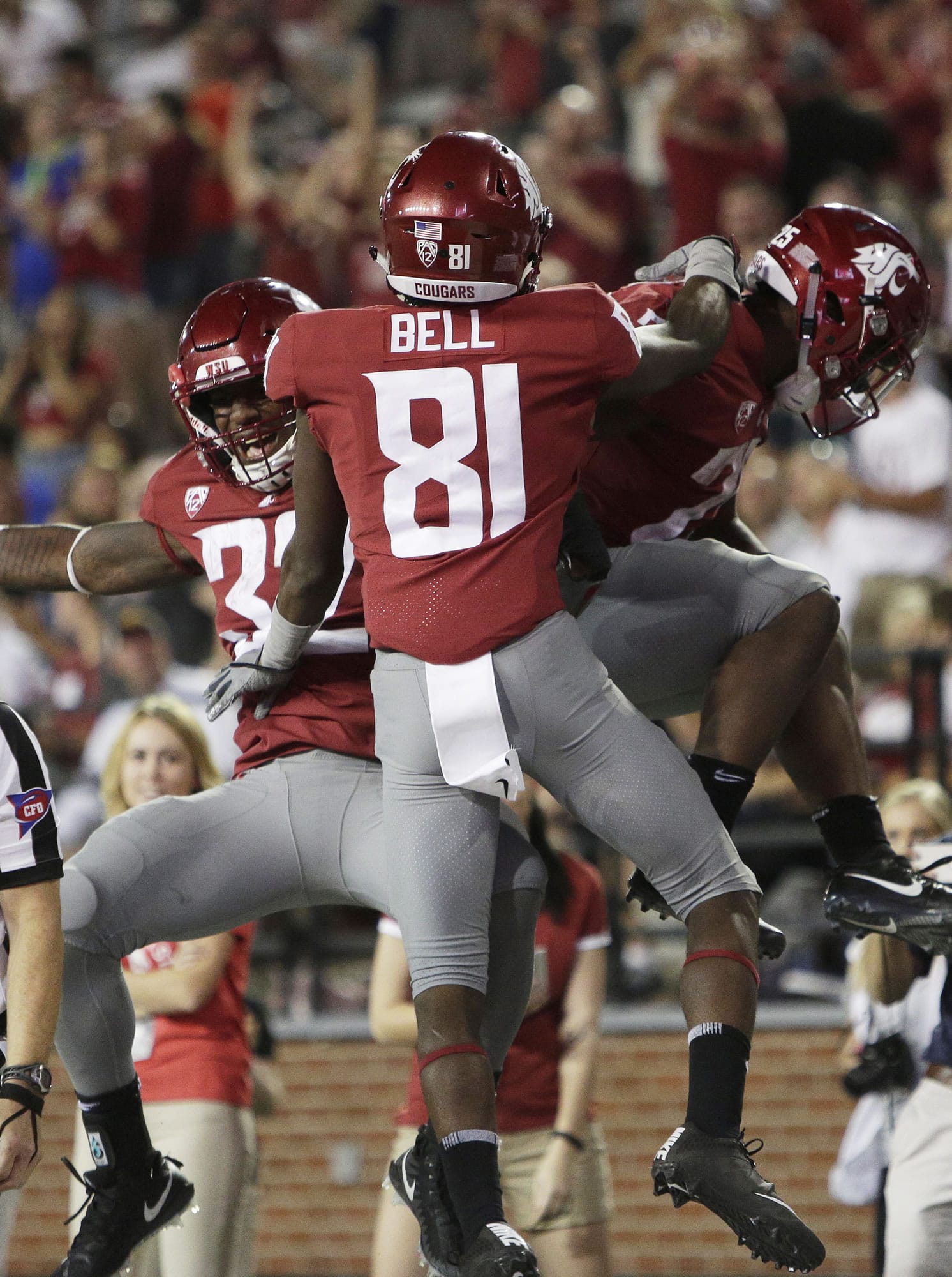 After scoring a touchdown, Washington State running back Jamal Morrow, right, celebrates with teammates wide receiver Renard Bell (81) and running back James Williams (32) during the second half of an NCAA college football game against Montana State in Pullman, Wash., Saturday, Sept. 2, 2017. Washington State won 31-0.