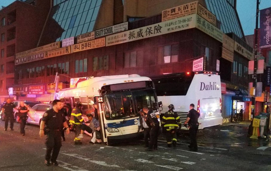 Officers respond to a collision involving two buses on Main Street in the Queens borough of New York, Monday, Sept. 18, 2017. The Fire Department of New York said several been hurt, some of them severely, when a city bus and a tour bus collided in the Flushing neighborhood.
