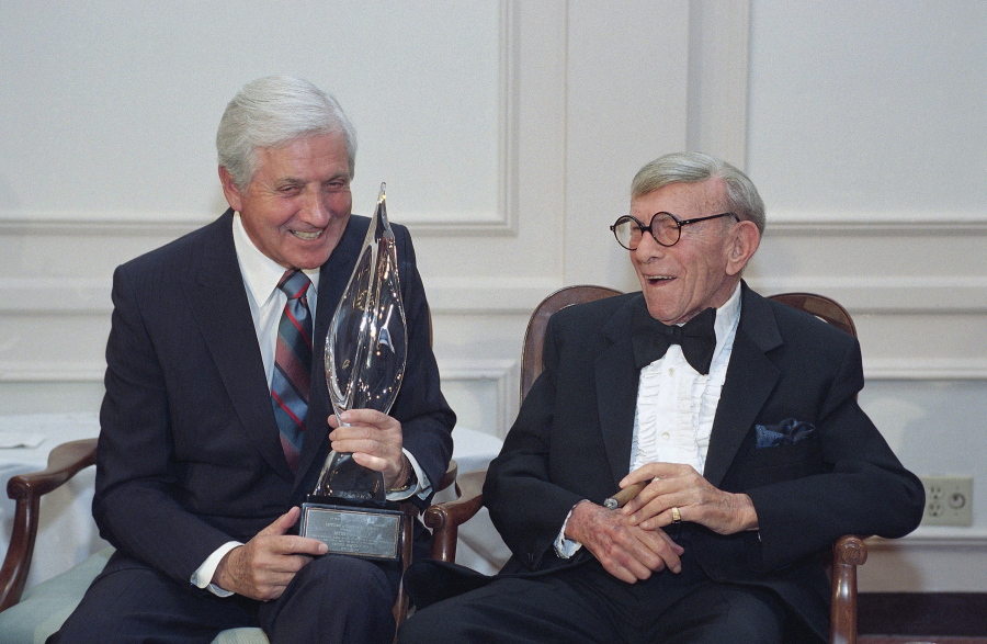 FILE - In this March 14, 1993, file photo, Monty Hall, left, recipient of the 2nd Annual George Burns Lifetime Award, laughs with George Burns at the United Jewish Fund tribute to humanitarian Hall, in the Century City section of Los Angeles. Former "Let's Make a Deal" host Hall has died after a long illness at age 96. His daughter Sharon Hall says he died Saturday, Sept. 30, 2017, at his home in Beverly Hills, Calif.