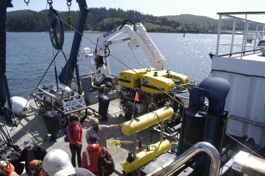 Crews work Aug. 25 at the stern of the EV Nautilus near Neah Bay in preparation for dives by the remotely-operated vehicles Argus, left, and Hercules in the Juan de Fuca Canyon in the Olympic Coast National Marine Sanctuary.