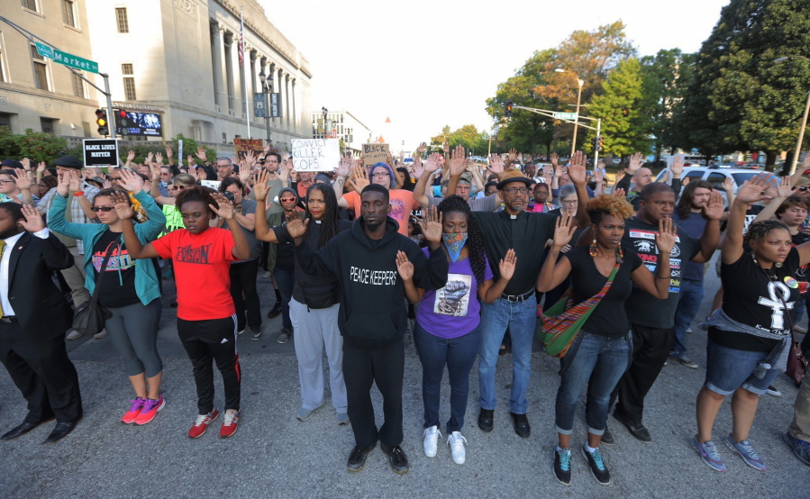 Protesters march in silence down Market Street in St. Louis on Monday in response to a not guilty verdict in the trial of former St. Louis police officer Jason Stockley. Stockley was acquitted on Friday in the 2011 killing of a black man following a high-speed chase. (Cristina Fletes/St.