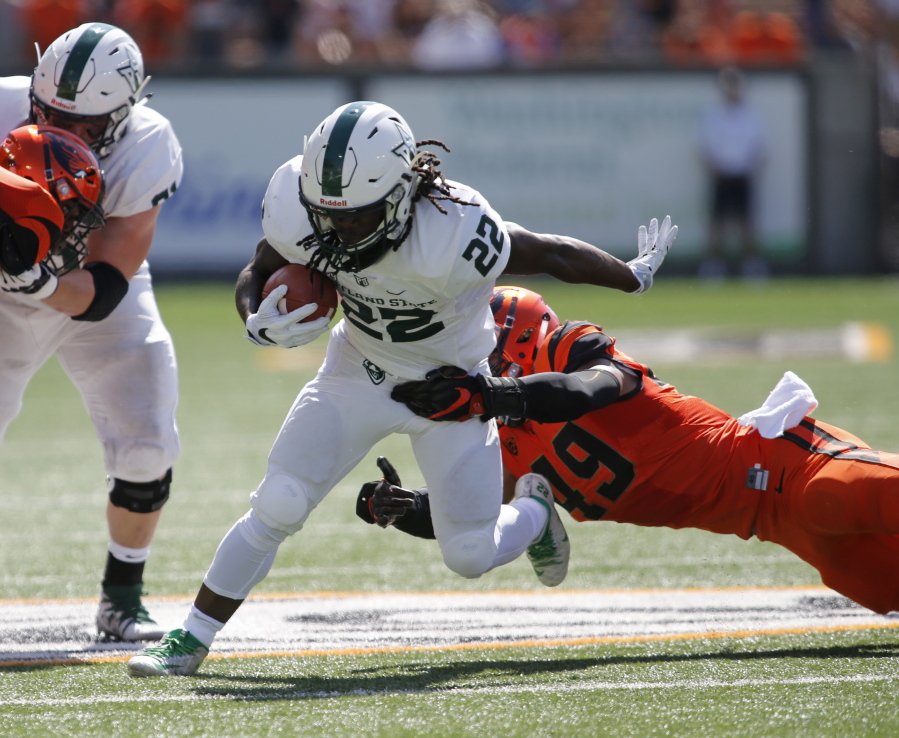 Portland State’s Za’Quan Summers (22) sheds the tackle attempt by Oregon State’s Andrzej Hughes-Murray (49) in the first half of an NCAA college football game, in Corvallis, Ore., Saturday, Sept. 2, 2017. (AP Photo/Timothy J.
