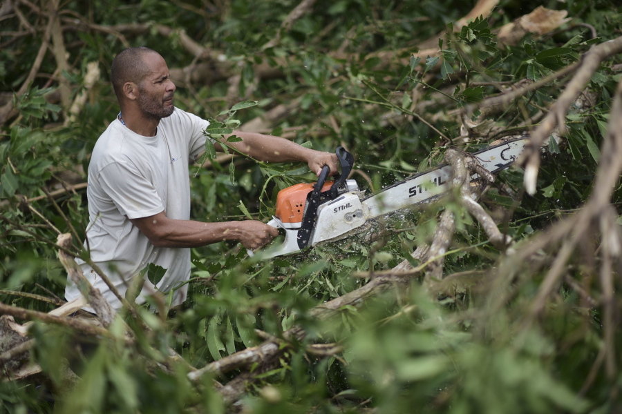 A municipal government worker clears a road after the passing of Hurricane Maria, in Yabucoa, Puerto Rico, Thursday, September 21, 2017. As of Thursday evening, Maria was moving off the northern coast of the Dominican Republic with winds of 120 mph (195 kph). The storm was expected to approach the Turks and Caicos Islands and the Bahamas late Thursday and early Friday.