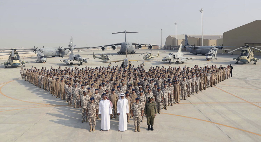 The Qatari Emir Sheikh Tamim bin Hamad Al Thani, centre front, poses for a photo with Emiri Air Force at al-Udeid Air Base in Doha, Qatar. Sheikh Tamim bin Hamad Al Thani’s visit to al-Udeid Air Base throws into sharp relief the delicate balancing act the U.S. faces in addressing the Qatar crisis.