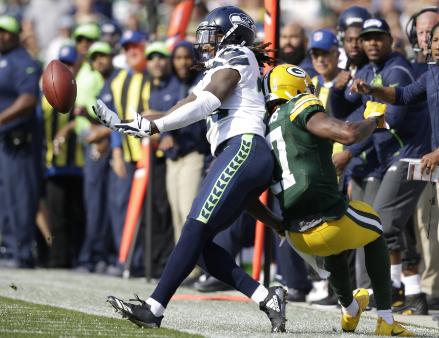 Seattle Seahawks’ Shaquill Griffin breaks up a pass intended for Green Bay Packers’ Davante Adams.
