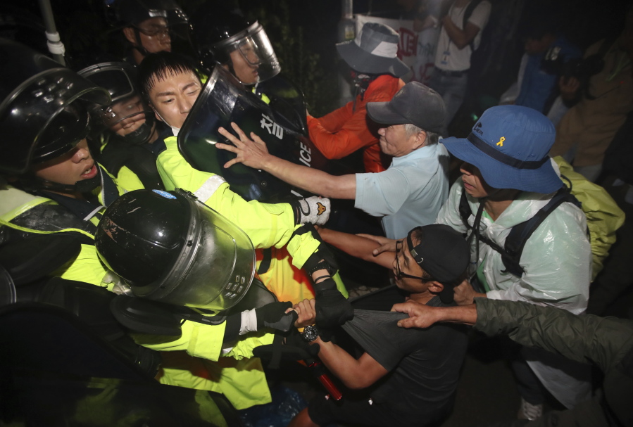 South Korean residents and protesters clash with police officers before the arrival of U.S. missile defense system called Terminal High Altitude Area Defense, or THAAD in Seongju, South Korea, on Thursday. Seoul’s Defense Ministry on Thursday said the U.S. military has completed adding more launchers to a contentious U.S. missile-defense system in South Korea to better cope with North Korean threats. The deployment of the Terminal High-Altitude Area Defense system has angered North Korea but also China and Russia, which see the system’s powerful radar as a threat to their own security.