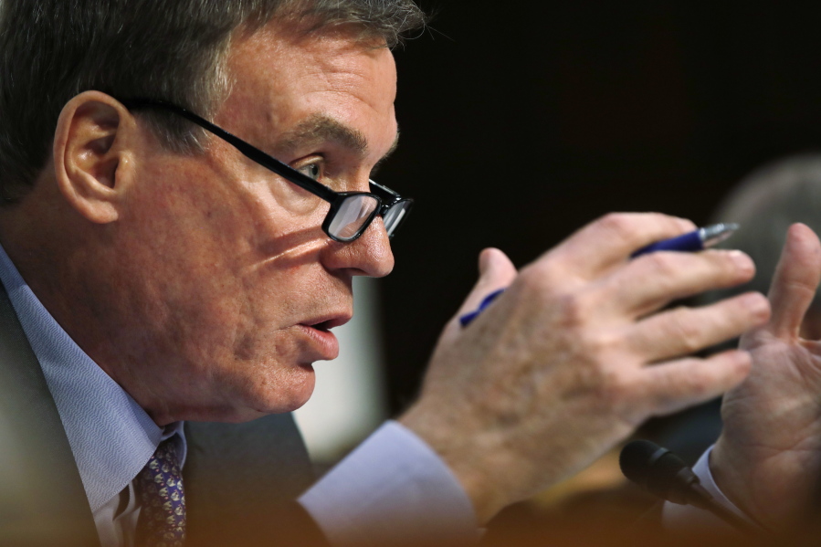 FILE - In this Tuesday, June 13, 2017, file photo, Senate Intelligence Committee Vice Chairman Sen. Mark Warner, D-Va., asks questions during a committee hearing on Capitol Hill in Washington. Warner is writing a bill that would require social media companies to disclose who funded political ads, similar to television broadcasters. Facebook CEO Mark Zuckerberg said Thursday, Sept. 21, 2017, that the company would require similar disclosures.