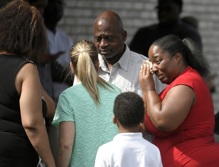Ieshea White cries tears of joy after being reunited with her uncle Roger Bracey, center, who was at Burnette Chapel Church of Christ when shots were fired Sunday, Sept. 24, 2017, in Antioch, Tenn. They were reunited at another nearby church.