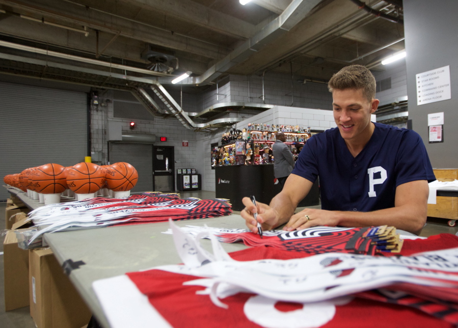 Portland Trail Blazers forward Meyers Leonard signs merchandise during media day at the Moda Center in Portland, Ore., Wednesday, April 12, 2017.