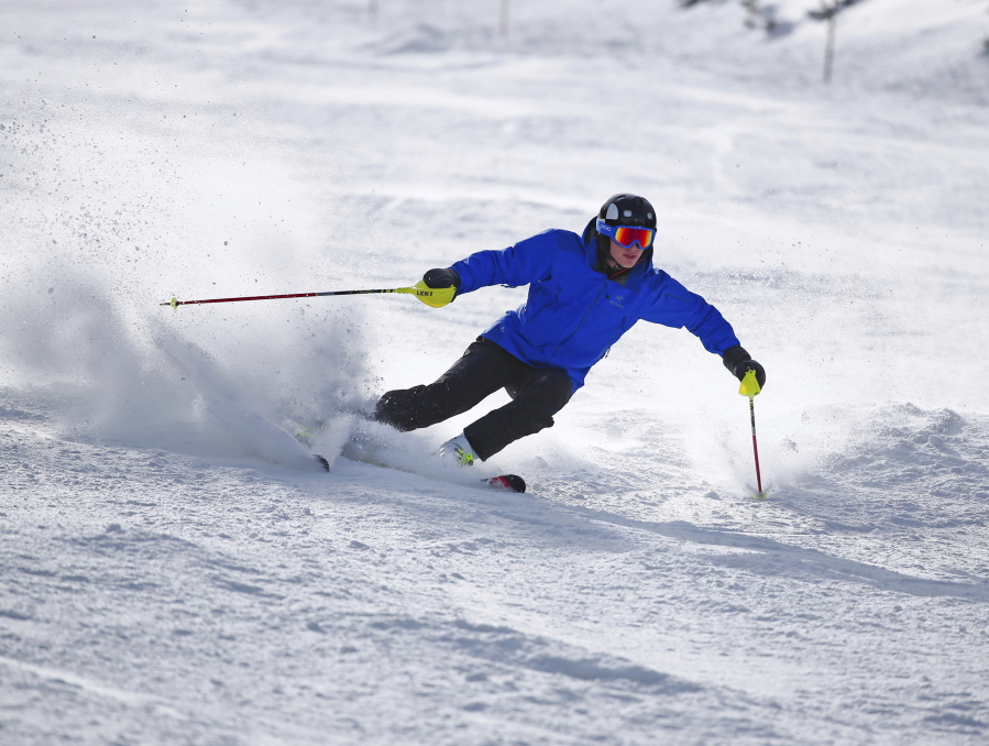 A skier kicks up some fresh powder Oct. 29, 2015, during opening day at Arapahoe Basin in Colorado. If you’re contemplating a ski vacation this winter, the best deals and discounts typically are offered well before winter. Some options sell out altogether as ski season approaches, especially nonstop flights and stays at ski-in, ski-out properties.