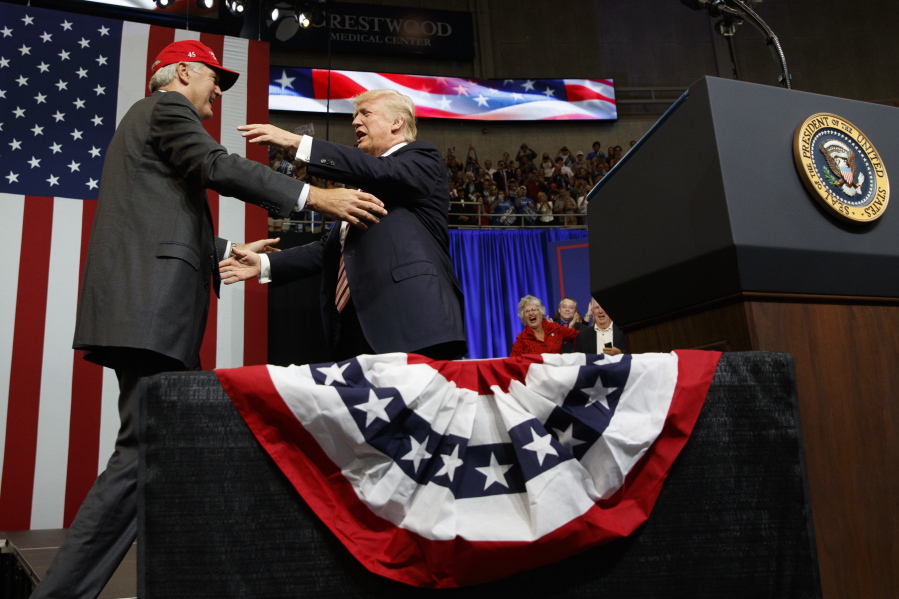 President Donald Trump hugs U.S. Senate candidate Luther Strange during a campaign rally Friday in Huntsville, Ala.