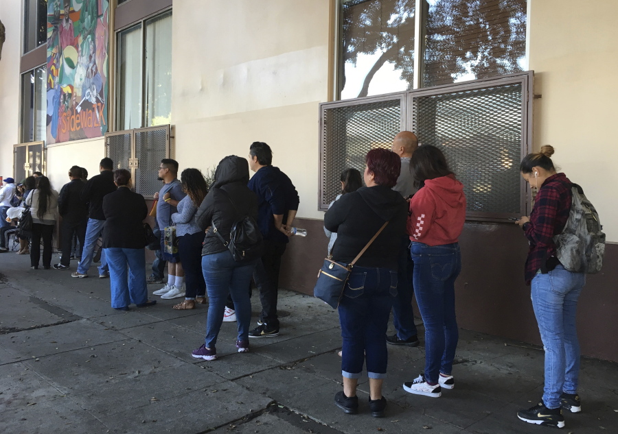 This Sept. 28, 2017 photo people wait in line at CHIRLA (Coalition for Humane Immigrant Rights Los Angeles) for help with immigration paperwork, including renewing work permits for expiring Obama-era program for immigrants brought to the country as children. After Oct. 5, 2017, no one else can renew under the program that has let nearly 800,000 immigrants brought to the United States as children work in the country even though they lack legal papers.