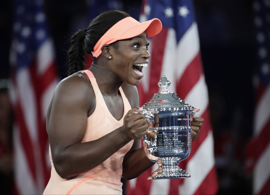 Sloane Stephens, of the United States, holds up the championship trophy after beating Madison Keys, of the United States, in the women’s singles final of the U.S. Open tennis tournament, Saturday, Sept. 9, 2017, in New York.