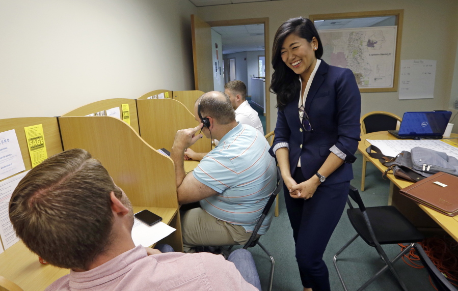 In this file photo taken Aug. 22, 2017, Jinyoung Lee Englund, candidate for 45th district Senate seat in Washington, talks with phone bank volunteers at her campaign headquarters in Woodinville, Wash. The Washington state Senate is the only Republican-led legislative chamber on the West Coast, and a special election in a district east of Seattle has drawn millions of dollars and national attention to two political newcomers vying for the seat this November. Democrat Manka Dhingra and Republican Englund are seeking to serve the last year of a four-year term in the 45th legislative seat left vacant by the death of Republican Sen. Andy Hill.