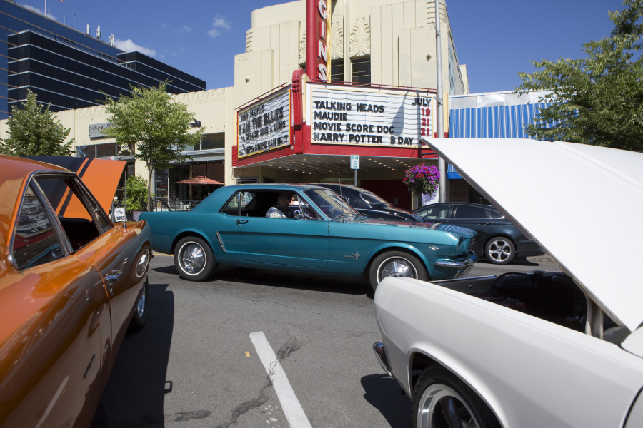 A vintage car passes the Kiggins Theatre as the driver takes part in Cruise the Couve on Main Street in downtown Vancouver on July 15. Vintage cars cruised up and down the road for the enjoyment of car aficionados and weekend visitors.
