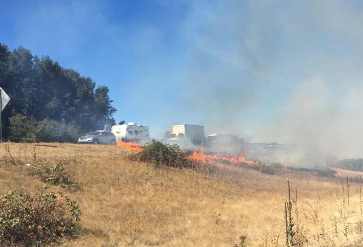 A fire in the median Interstate 5 in Woodland is blocking lanes of traffic in the area.