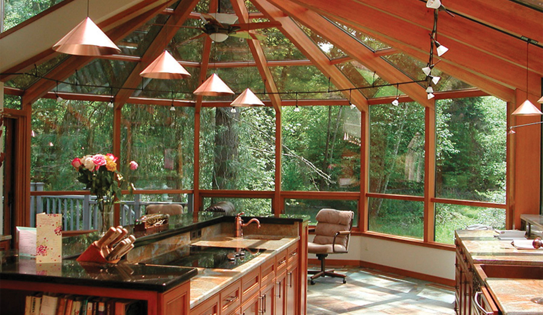 An outdoor kitchen protected from the elements. Sunrooms provide natural light throughout the day.