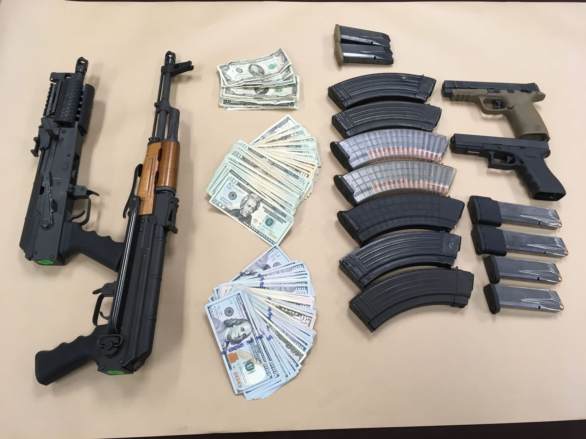 Firearms and cash seized Tuesday as part of a drug trafficking investigation.