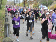 Joleen Skarberg, right, in purple, and her daughter Megan Skarberg, to left, run in the 2014 Girlfriends Run for a Cure half marathon.