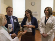 Imaging manager Julie Bogh, left, Legacy Salmon Creek Medical Center president Bryce Helgerson, breast surgeon Dr. Cory Donovan and breast cancer survivor Liz Stanley on a tour of the center.