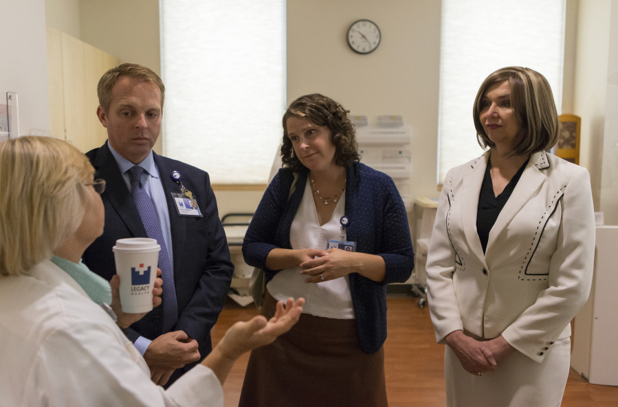 Imaging manager Julie Bogh, left, Legacy Salmon Creek Medical Center president Bryce Helgerson, breast surgeon Dr. Cory Donovan and breast cancer survivor Liz Stanley on a tour of the center.
