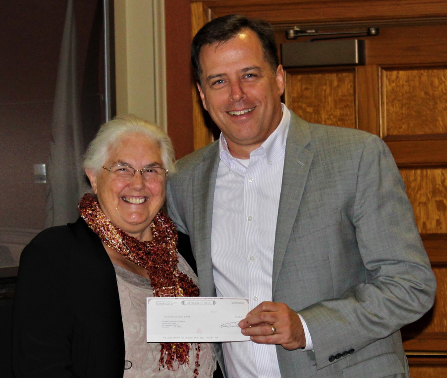 Honorable Frank L. and Arlene G. Price Foundation Executive Director Kay Dalke-Sheadle, left, presents a check for $20,000 to John Vanderkin, Workforce Southwest Washington board chairman, to help fund a Kelso youth workforce training program.