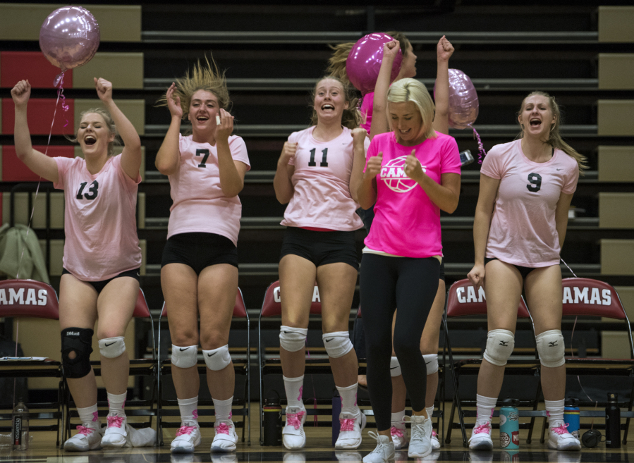 Camas coach Michelle Allen and her players celebrate a point at the end of the third set during Tuesday’s four-set league victory over Union.