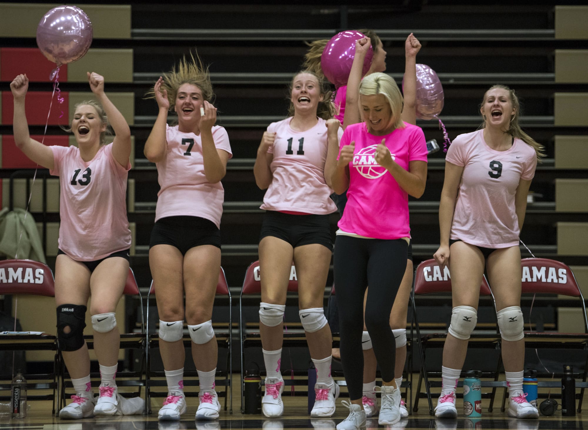 Camas High School celebrates a point at the end of the third set during Tuesday night's game at Camas High School on Oct. 3, 2017. Camas High School won 3-1.