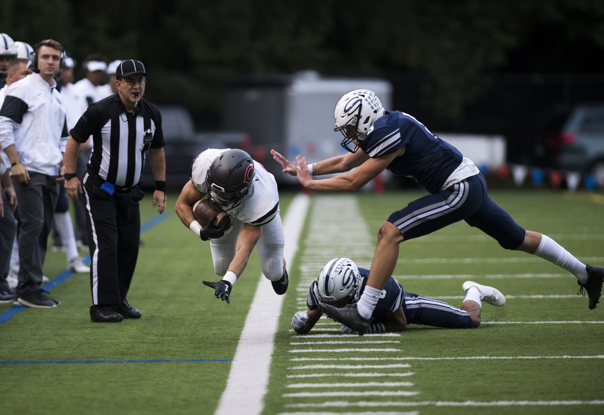 Skyview's Tavis Pinkney (6), center, and Chad Eigsti (5) force Camas' Will Schultz (37) out of bounds during Friday night's game Kiggins Bowl in Vancouver on Oct. 6, 2017. Camas defeated Skyview 38-20.