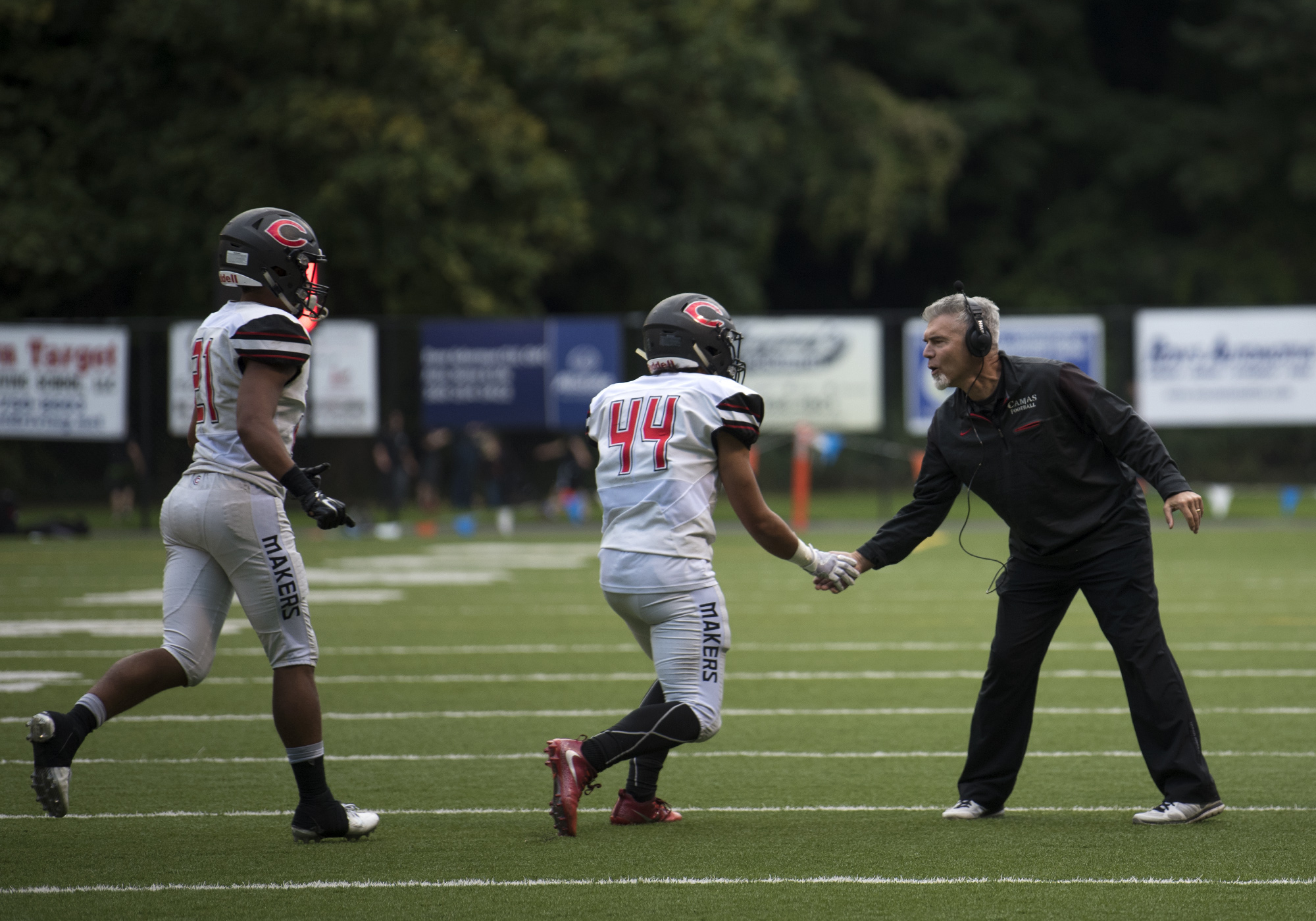 Camas head coach Jon Eagle congratulates Semisi Schultz (44) after his touchdown during Friday night's game at Kiggins Bowl in Vancouver on Oct. 6, 2017. Camas defeated Skyview 38-20.