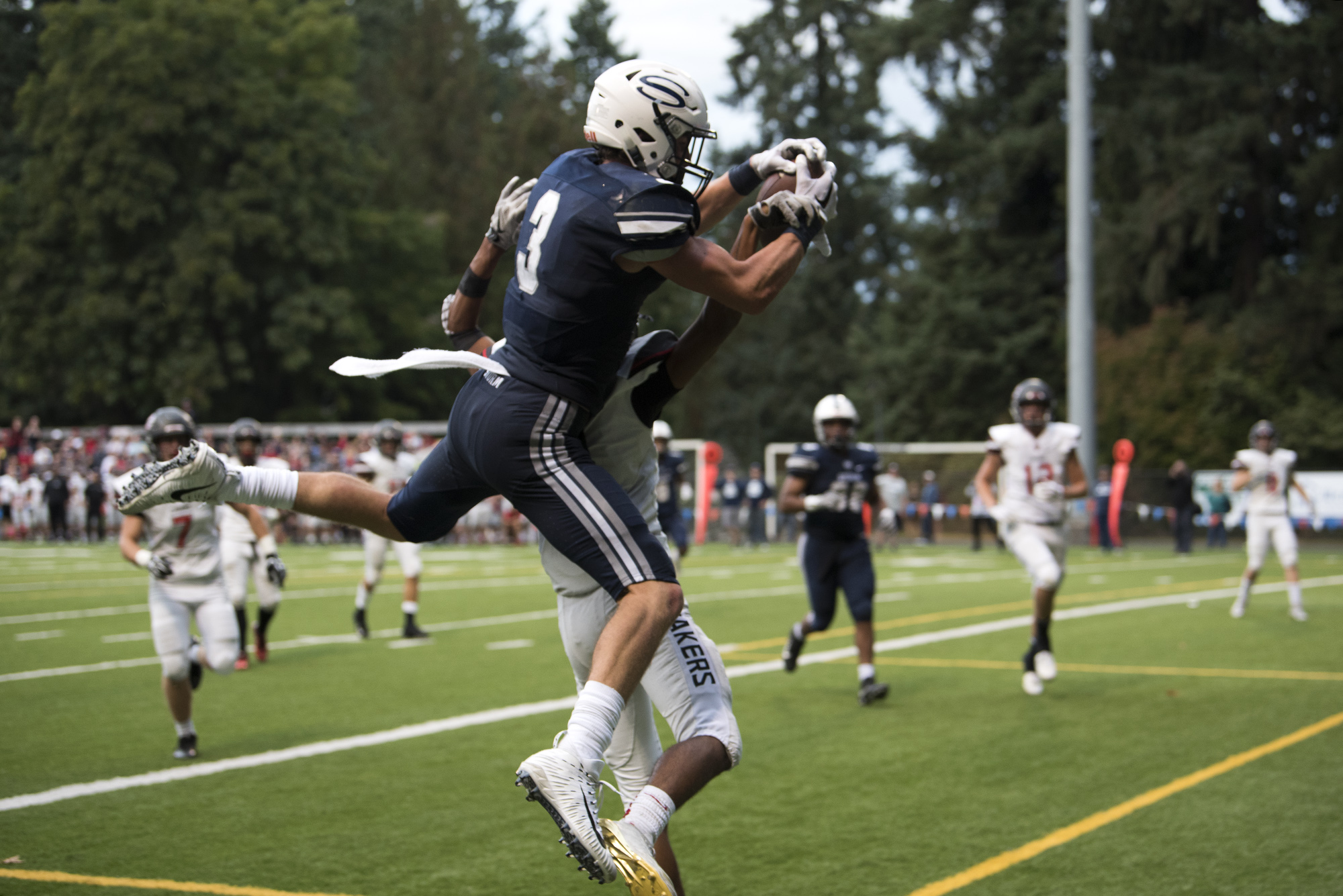 Skyview's Cole Grossman (3) catches the ball for a touchdown as Camas' Isaiah Abdul (2) tries to block him during Friday night's game at Kiggins Bowl in Vancouver on Oct. 6, 2017. Camas defeated Skyview 38-20.