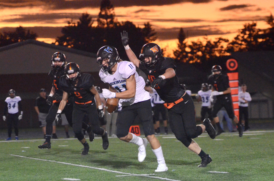 Hockinson receiver Sawyer Racanelli runs the ball with Washougal line backer Nathan Tofell looming over him at Washougal High School on Friday, October 6, 3017.