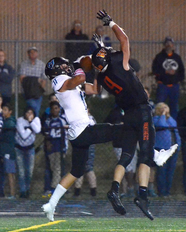 Hockinson receiver Sawyer Racanelli catches a touchdown pass over Washougal defensive back Dalton Payne at Washougal High School on Friday, October 6, 2017.