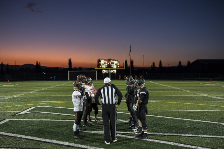 Washougal and Woodland captains meet for the coin toss before Friday night's game at Woodland High School on Oct. 13, 2017. Woodland defeated Washougal 20-7.