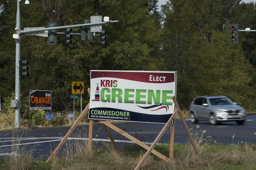 Campaign signs for Port of Vancouver District 1 commission candidates Kris Greene and Don Orange sit at the intersection of Northwest 78th Street and Northwest Lakeshore Avenue. Greene’s former campaign strategist claims energy industry insiders wield a heavy influence in the contentious race.
