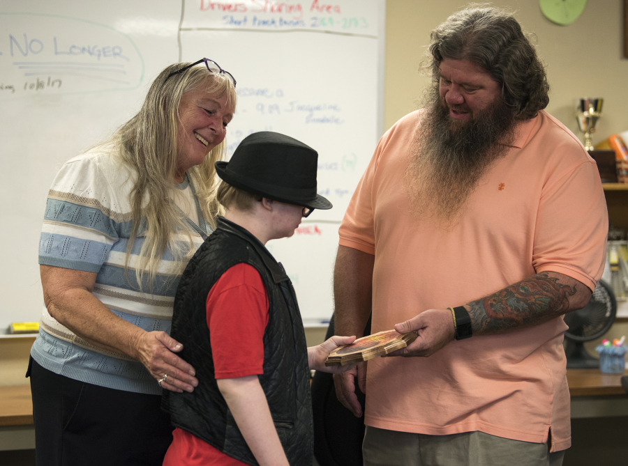 Dionna J’orgensen and her grandson, Colby Standridge, 13, present a token of appreciation to John Shreves at the C-Tran offices in Vancouver on Monday. On Aug. 4, Shreves noticed something was amiss when Colby got on his bus. He helped return him to his family.