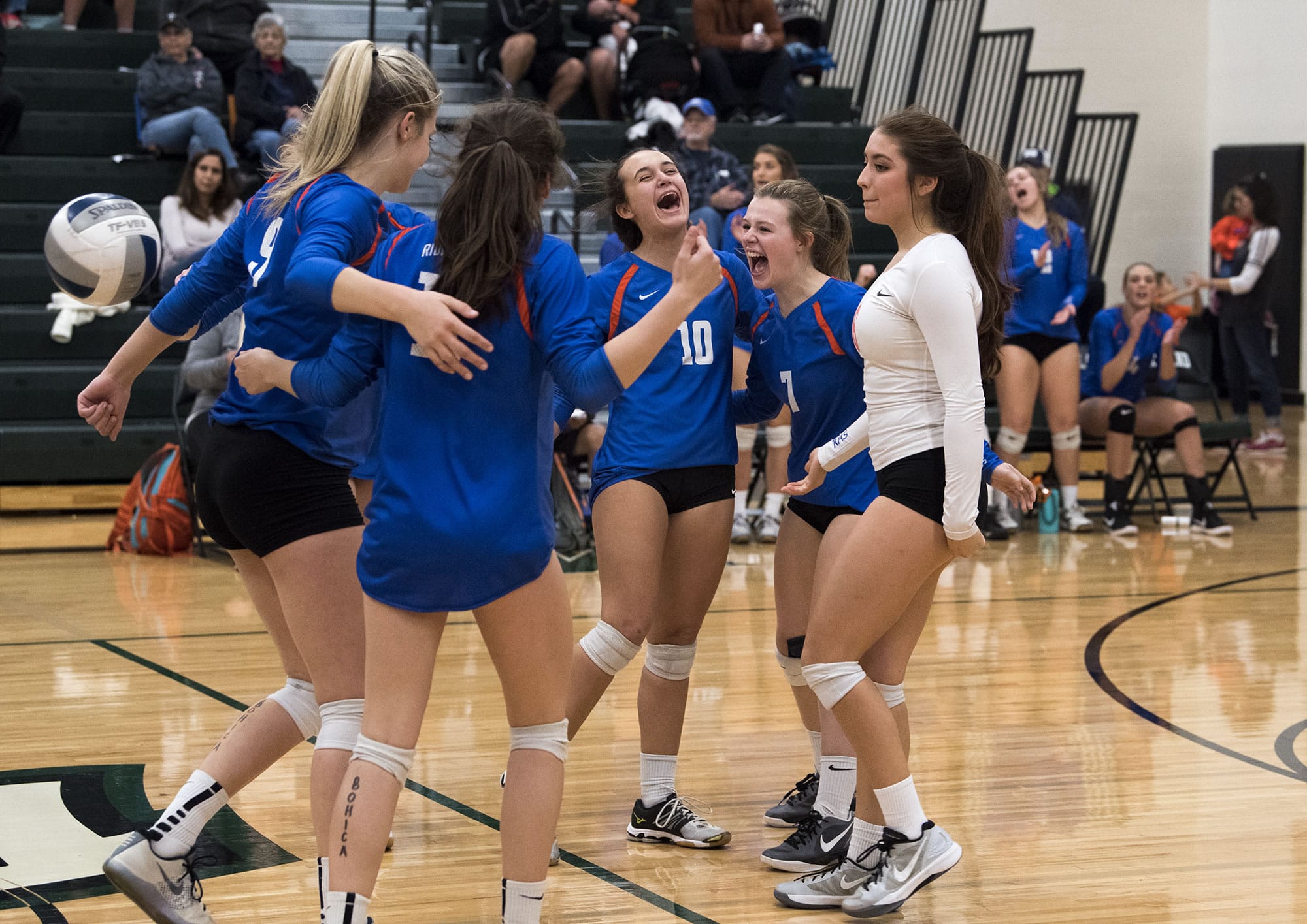 Ridgefield celebrates a point during the match at Woodland High School on Tuesday evening, Oct. 17, 2017. Woodland won the match 3-1.