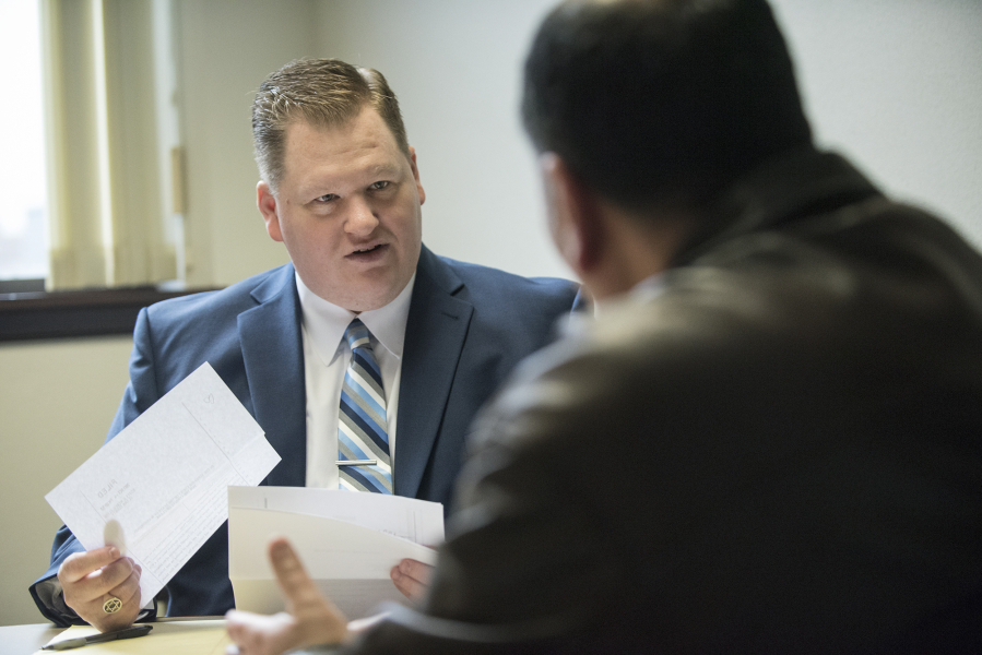 Volunteer attorney Ben Moody gives a client legal advice during a meeting at the Clark County Courthouse on Friday. Moody typically volunteers every Friday giving advice to people facing evictions.