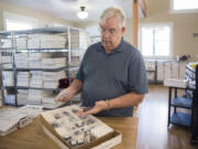 John Van Rees Sr., co-owner of Exquisite Crystals in Vancouver, looks though crystal inventory while in his shop, located in the old Vancouver Barracks Dental Surgeon’s office.