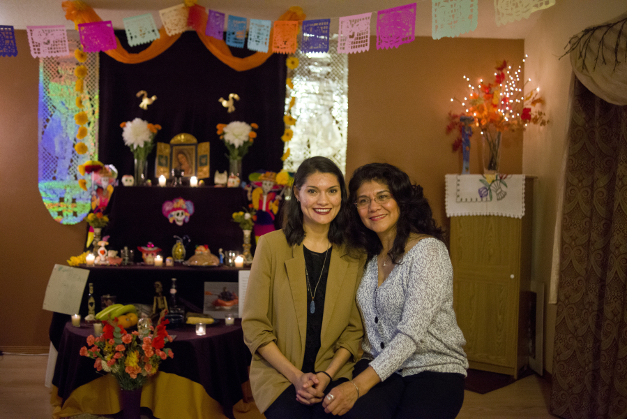 Gloria Pitkin, left, and her mother, Rosalba Pitkin, are pictured in front of an ofrenda, or altar, set up in their living room to commemorate deceased loved ones for Day of the Dead. “This is my family’s tradition. This is my history and my home. It’s very important to me to know about it and know what it means,” Gloria Pitkin said.