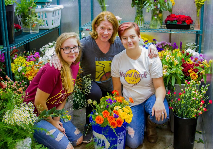 Woodland: Woodland High school junior Kylee Jones, from left, Mary Ellen Vetter, who teaches horticulture and floral design courses at the school, and Jennifer-Parkhill at Floral Design Institute’s FloraChopped competition last month, where the two Woodland teams finished first and second.