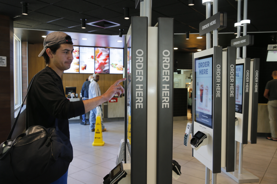 A customer orders food at a self-service kiosk at a McDonald’s restaurant in Chicago in June.