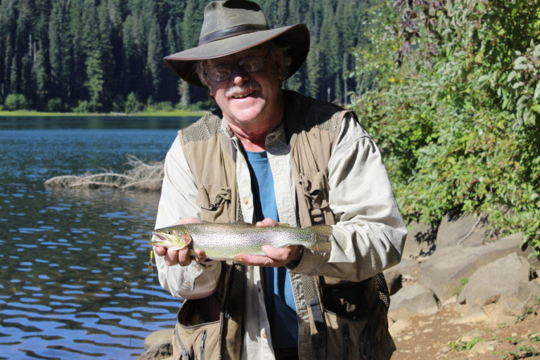 The author holds a chunky Goose Lake cutthroat trout. The lake’s cutthroats draw anglers to the lake in October.