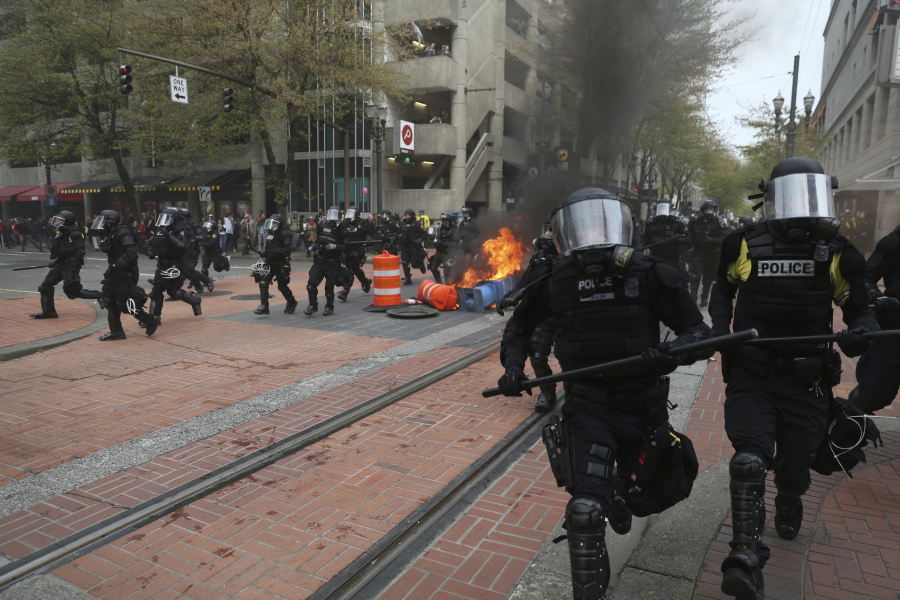 Portland police try to disperse people on May 1 at a protest march that turned violent in downtown Portland.