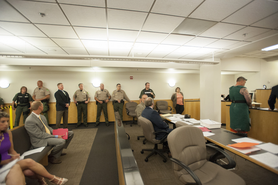 Courtroom security was increased as triple-homicide suspect Brent Ward Luyster, right, makes a first appearance July 18, 2016, in Clark County Superior Court. Luyster is accused of fatally shooting three people and wounding a fourth July 15, 2016, at a Woodland area home. His aggravated murder trial begins today.