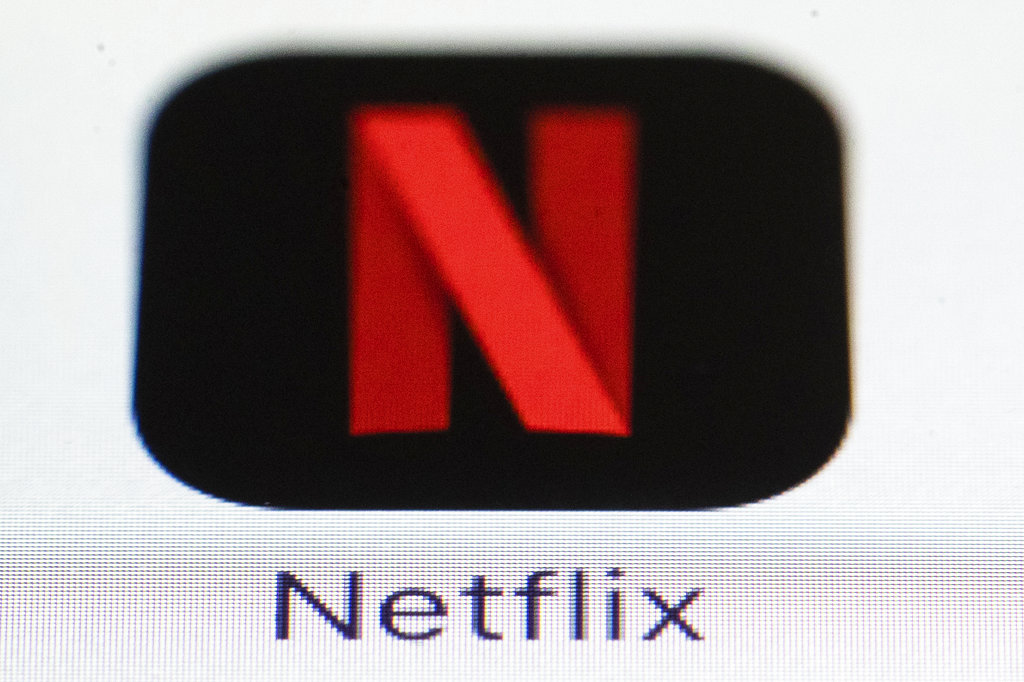 This Monday, July 17, 2017, photo shows the Netflix logo on an iPhone. On Thursday, Oct. 5, 2017, Netflix announced it is raising the price for its most popular U.S. video streaming plan by 10 percent in a move that may boost its profits, but slow the subscriber growth that drives its stock price.